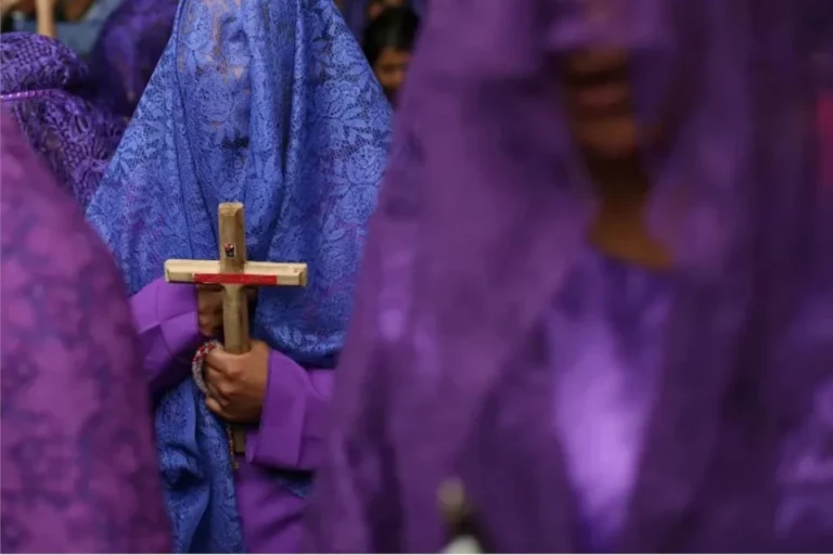 Devotee holding a cross during Holy Week near Casa Gangotena in Quito.