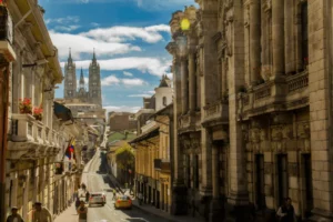Historic street view of Hotel Quito with Casa Gangotena Boutique and iconic cathedral in the background.