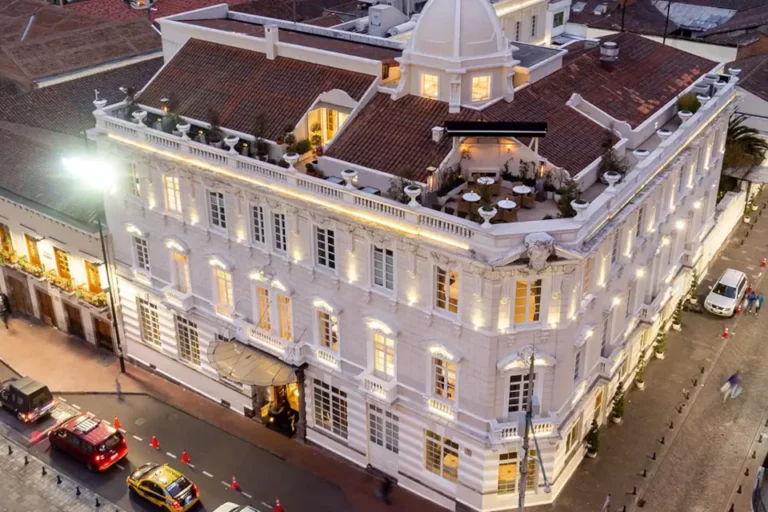 Aerial view of Casa Gangotena Boutique Hotel in Old Town Quito, illuminated at dusk.