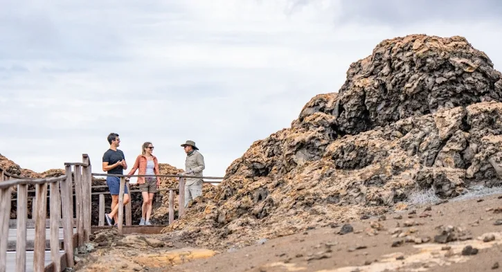 Guests from Casa Gangotena Boutique Hotel engaging with a guide on Bartolome Island, Galapagos.