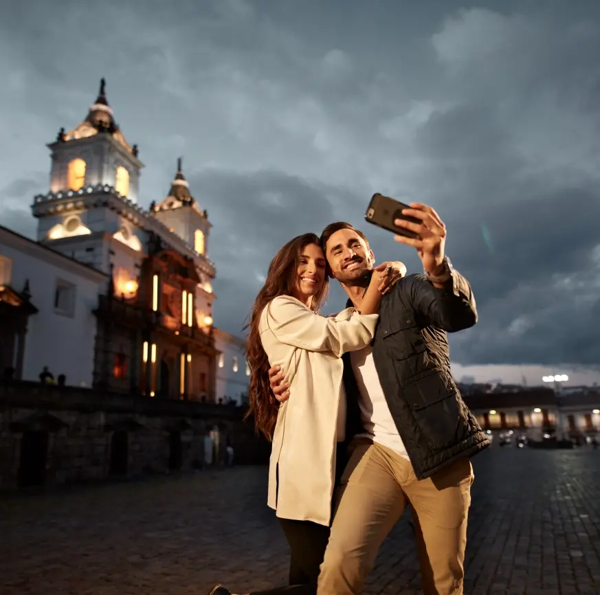 Couple capturing a moment in front of Casa Gangotena and Iglesia de San Francisco in Quito.