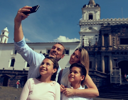 Family taking a selfie near Casa Gangotena Boutique Hotel in Quito's historic district.