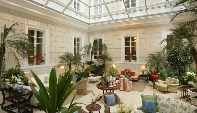 Lush indoor oasis at Casa Gangotena, epitomizing Gangotena Boutique's luxurious ambiance in Hotel Quito. Lush indoor oasis at Casa Gangotena, epitomizing Gangotena Boutique's luxurious ambiance in Hotel Quito.